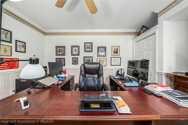 office area with ceiling fan, ornamental molding, and wood walls