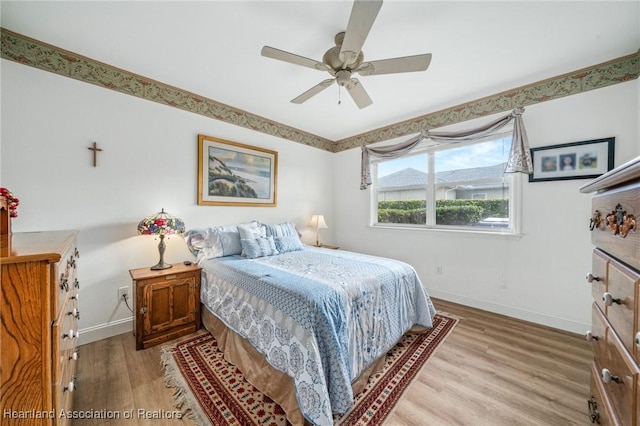 bedroom with ceiling fan and light hardwood / wood-style flooring