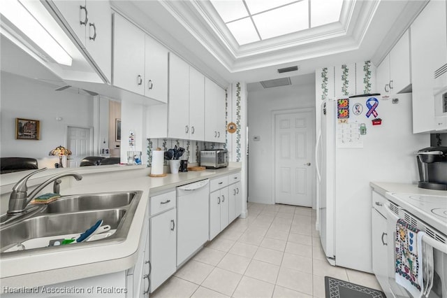 kitchen with white dishwasher, crown molding, white cabinets, and sink