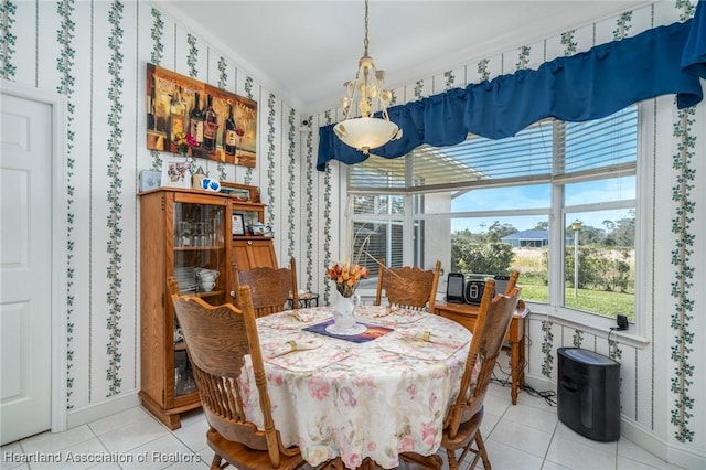 dining room with tile patterned floors and crown molding