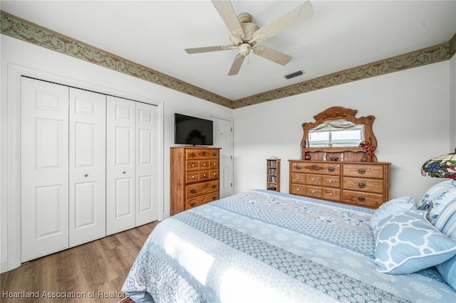 bedroom with ceiling fan, light wood-type flooring, and a closet