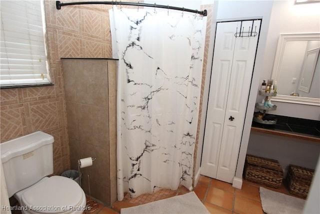 bathroom featuring walk in shower, tile patterned flooring, and toilet