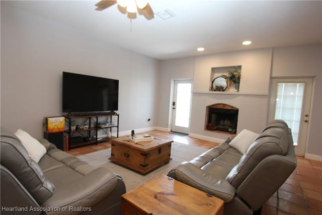 living room with ceiling fan and light tile patterned floors