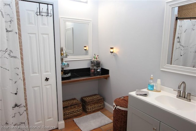 bathroom featuring a shower with shower curtain, vanity, and tile patterned floors