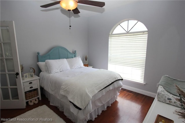 bedroom with ceiling fan and dark hardwood / wood-style flooring