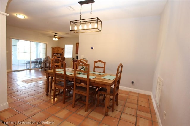 dining area featuring tile patterned floors and ceiling fan