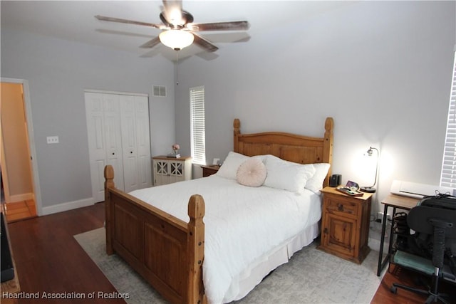 bedroom featuring hardwood / wood-style flooring, ceiling fan, and a closet