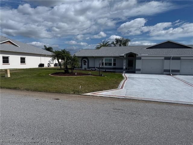 view of front of house with a garage and a front lawn