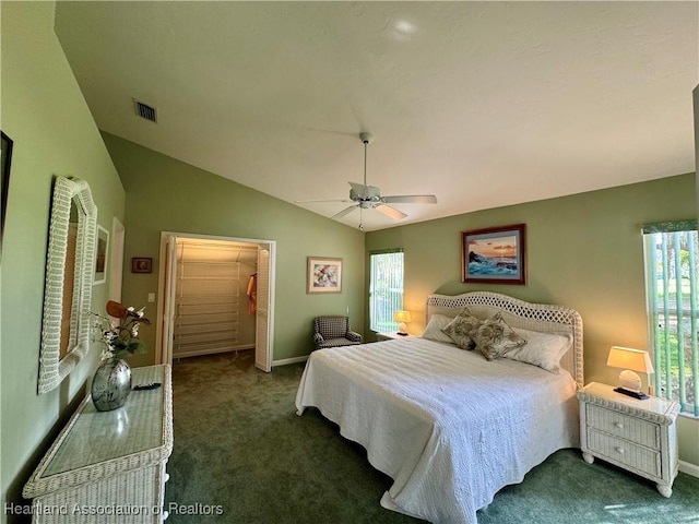 carpeted bedroom featuring lofted ceiling, a closet, visible vents, ceiling fan, and baseboards