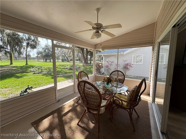 sunroom featuring vaulted ceiling and ceiling fan