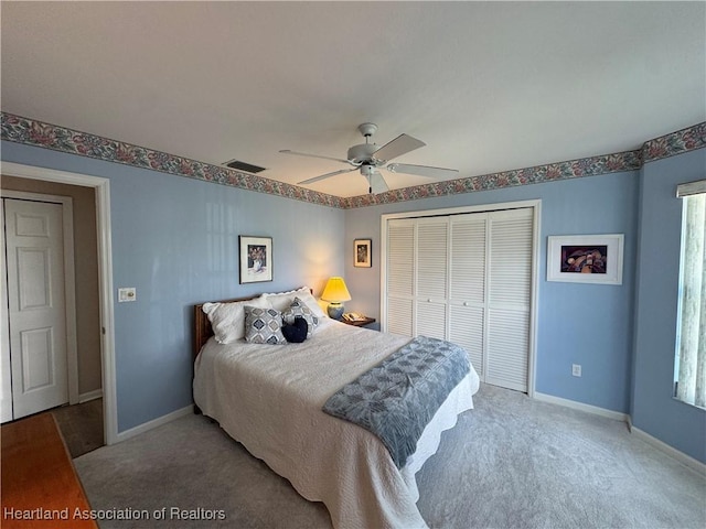 bedroom with light carpet, a closet, visible vents, and baseboards