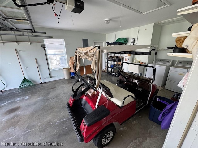 garage featuring a garage door opener and independent washer and dryer