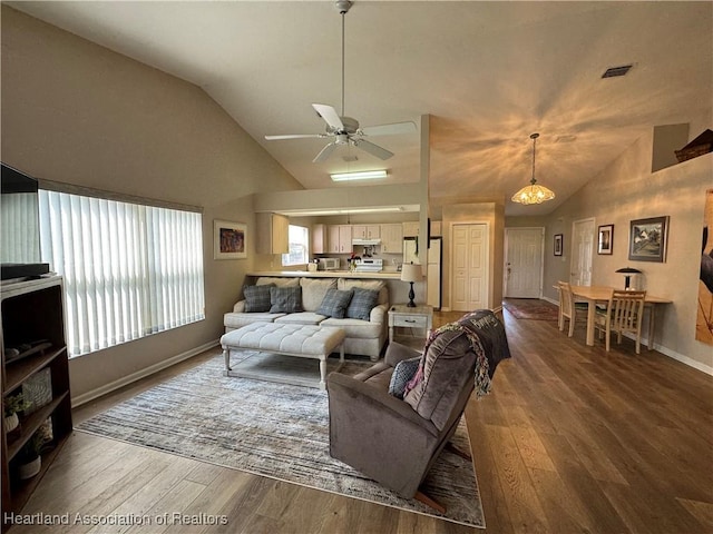 living room with visible vents, ceiling fan, wood finished floors, high vaulted ceiling, and baseboards