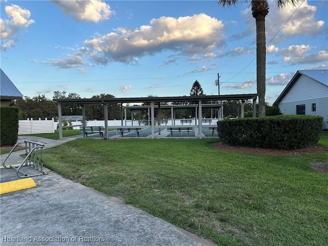 exterior space with fence and a lawn