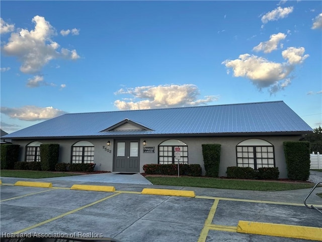 view of building exterior with uncovered parking
