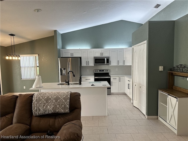 kitchen with light countertops, visible vents, appliances with stainless steel finishes, a sink, and hanging light fixtures