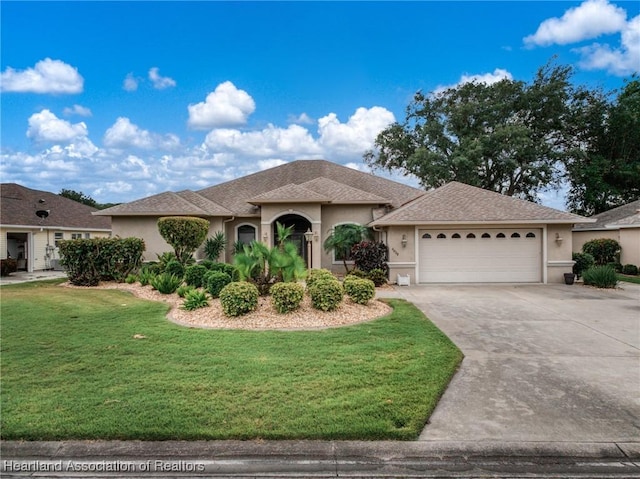 view of front of home featuring a garage, stucco siding, concrete driveway, and a front yard