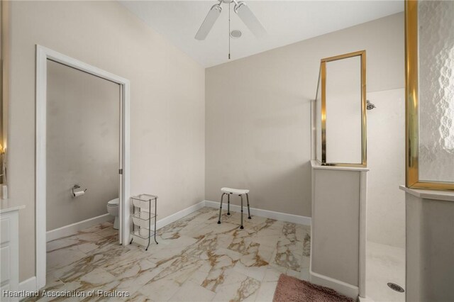 full bath with a walk in shower, toilet, marble finish floor, a ceiling fan, and baseboards