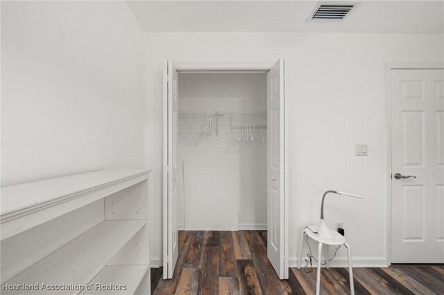 interior space featuring dark wood-style flooring and visible vents
