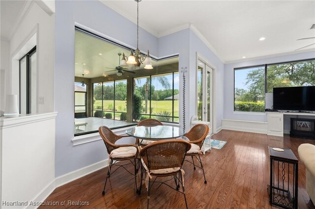 dining room featuring baseboards, ornamental molding, a ceiling fan, and hardwood / wood-style flooring