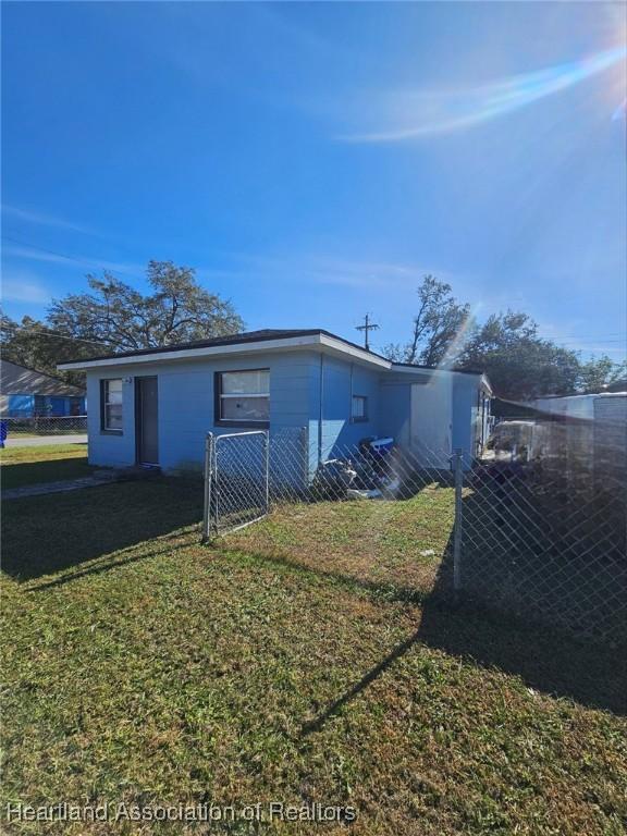 view of side of property featuring a yard and fence