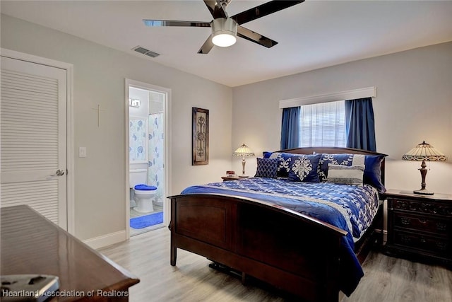 bedroom featuring connected bathroom, light hardwood / wood-style floors, and ceiling fan