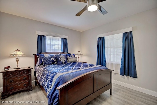 bedroom with ceiling fan and light hardwood / wood-style floors