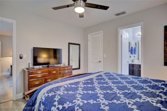 bedroom with ceiling fan and connected bathroom