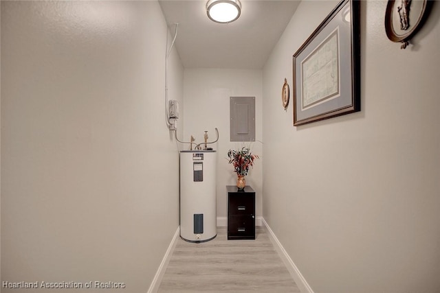 corridor with electric panel, water heater, and light wood-type flooring