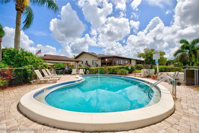 view of swimming pool featuring a gazebo, a patio area, and cooling unit