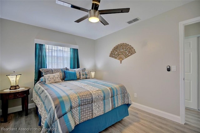 bedroom with ceiling fan and wood-type flooring