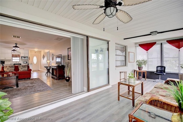 sunroom featuring ceiling fan