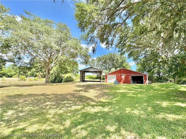 view of yard featuring a detached garage, an outbuilding, and an outdoor structure