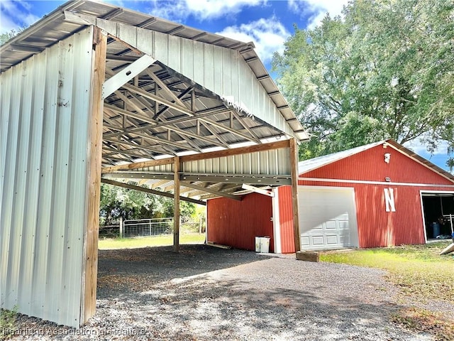 view of vehicle parking with a garage and fence