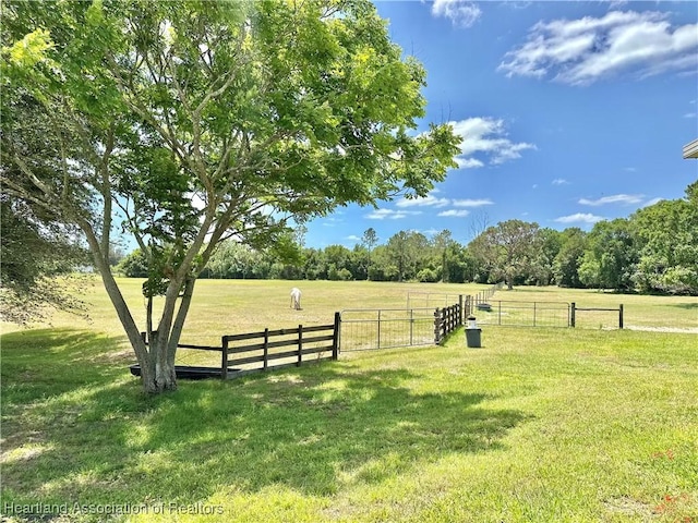 view of yard featuring fence and a rural view