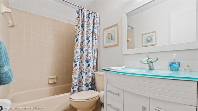 full bathroom featuring shower / bath combo, vanity, and toilet