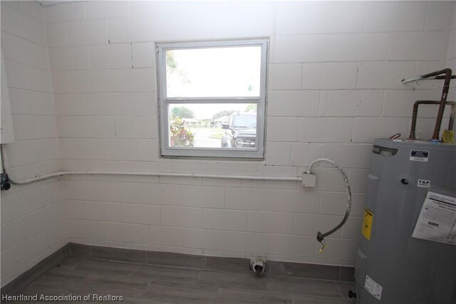 laundry room featuring water heater