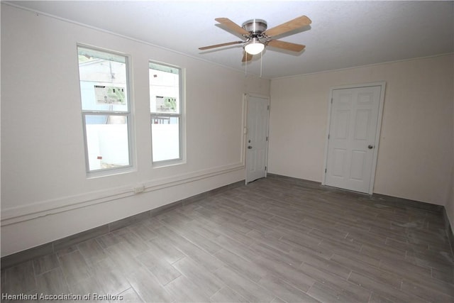 empty room featuring hardwood / wood-style flooring and ceiling fan