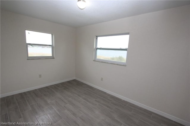 unfurnished room featuring dark hardwood / wood-style flooring