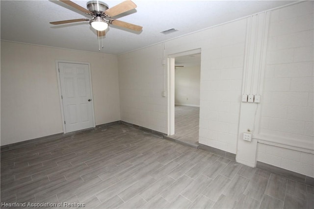 empty room with hardwood / wood-style floors and ceiling fan