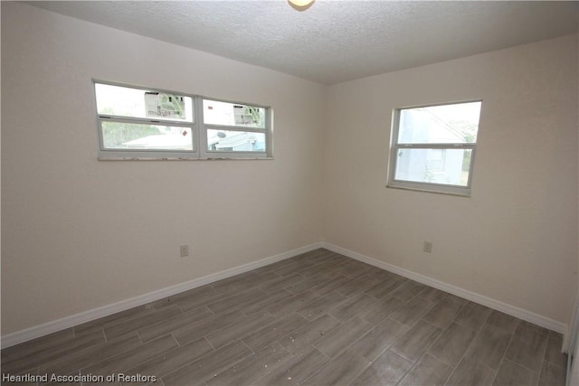 spare room with a wealth of natural light and a textured ceiling