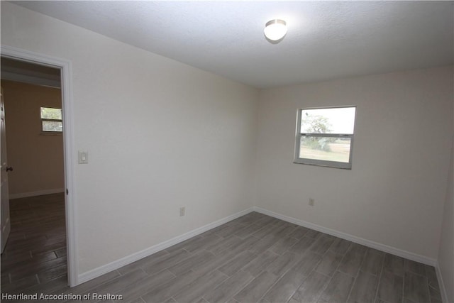 empty room with dark wood-type flooring