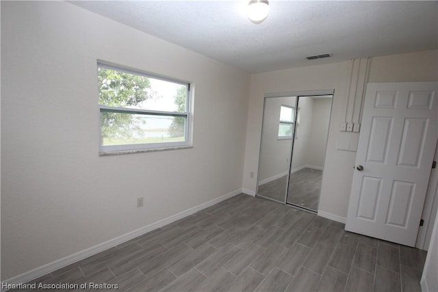 unfurnished bedroom featuring hardwood / wood-style flooring and a closet