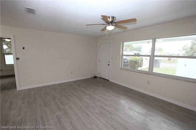 unfurnished room with hardwood / wood-style floors and ceiling fan