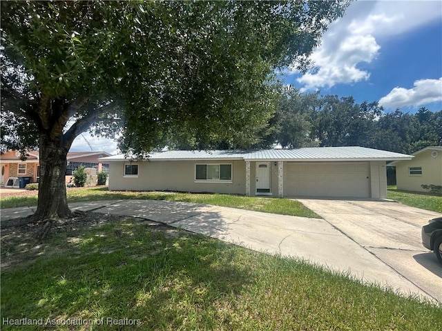 ranch-style home with a garage and a front lawn