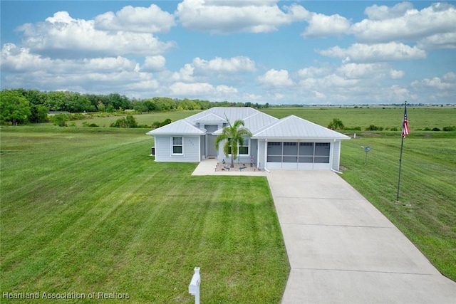 single story home with a rural view, a garage, and a front lawn