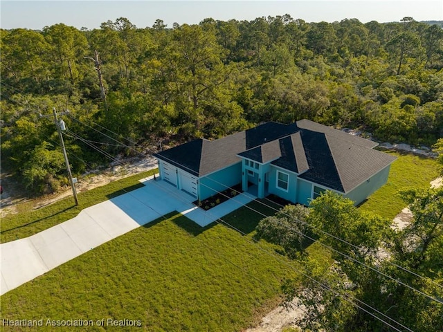birds eye view of property with a forest view