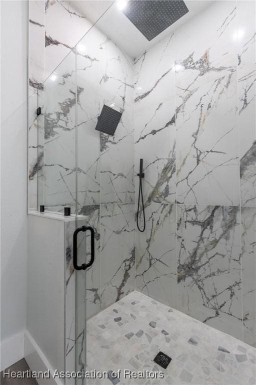 bathroom with a marble finish shower