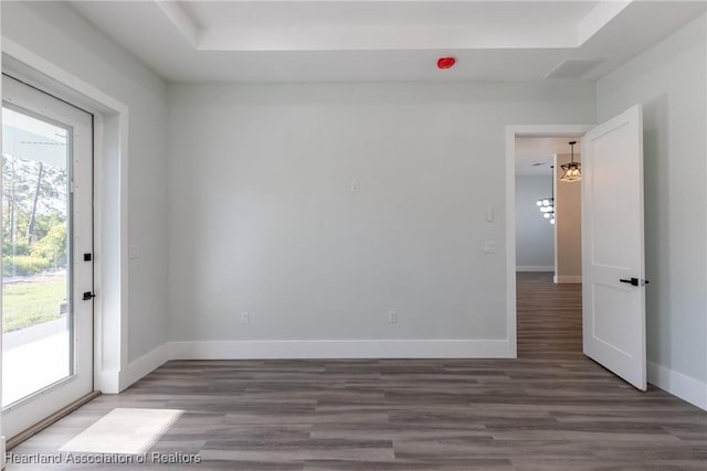 empty room featuring wood finished floors and baseboards