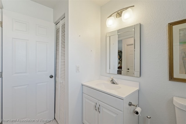 bathroom featuring vanity and toilet